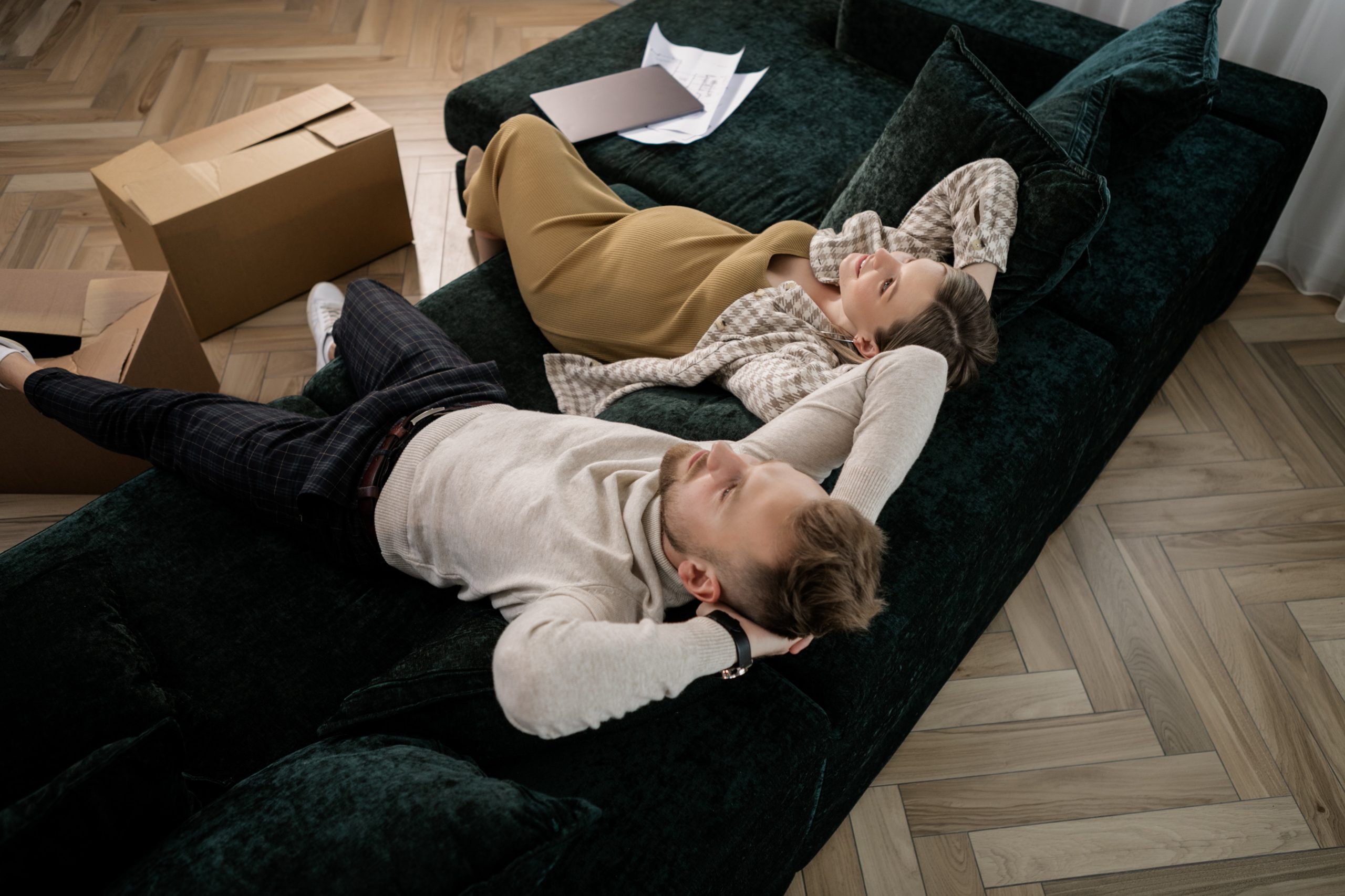 Couple on sofa with moving boxes