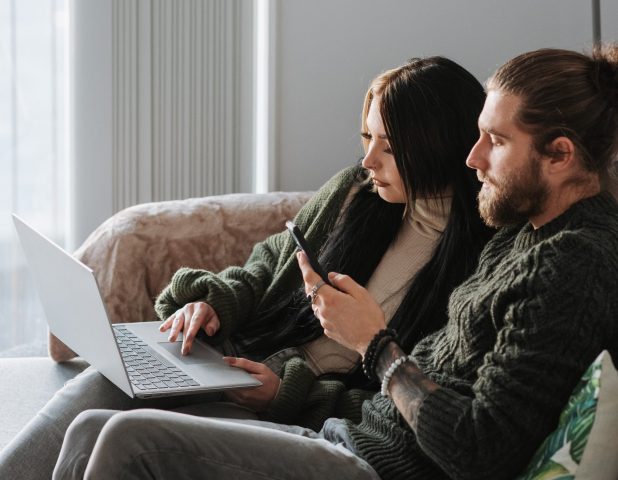 Couple with laptop on sofa